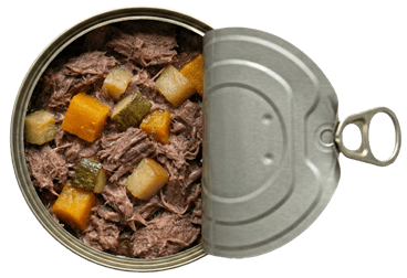 Prémium kutyakonzerv felülnézetből, félig nyitott fedéllel, benne látható párolt marhahús darabokkal, sütőtökkel, cukkinivel és almával.